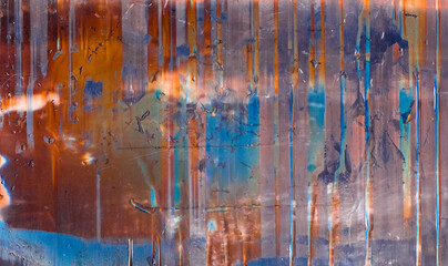 Wet grunge background. Paint drip texture. Rusty orange purple blue screen defect with water drops.