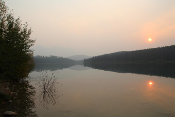 Fototapeta na wymiar Smoky Sunset On Patricia Lake, Jasper National Park, Alberta