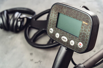 Metal detector tool on concrete background close up