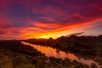 Kanchanaburi city and  with River Kwai noi in the sunrise. View point from the Wat Tham Kaophoon. Kanchanaburi province-Thailand.