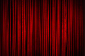 Beautiful red curtains of the stage lit with stage lights, moments before the curtains went up to reveal the stage