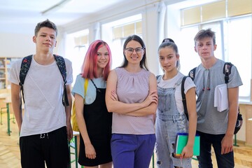 Fototapeta Group of teenagers with teacher, portrait of students and tutor in classroom obraz