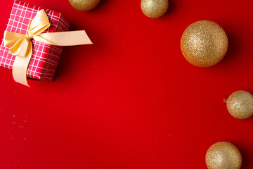 Christmas baubles and wrapped gift decorated with bow