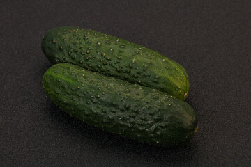 Green fresh cucumbers over background