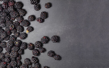 Fresh ripe blackberries on a black background.