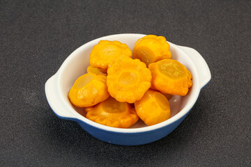 Marinated yellow patisson in the bowl