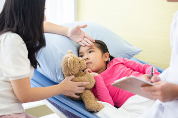 Sick child girl on bed in hospital with mother take care, Doctor doing treatment. healthy and care concept.