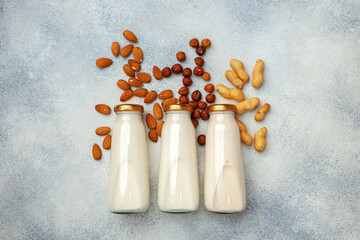 Vegan non dairy nut milk and heaps of different nuts top view