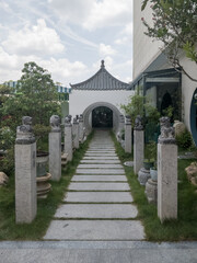 stone statues on pillars outside a Chinese building