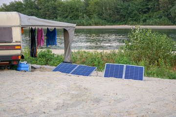 Solar panels power the mobile home on a trip. Camping on the river.