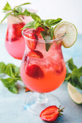 Glass of fresh strawberry mojito on color background