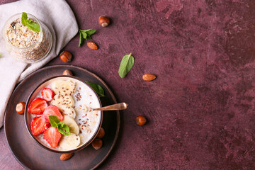 Bowl with tasty sweet oatmeal on color background