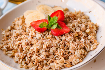 Bowl with tasty sweet oatmeal, closeup