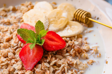 Bowl with tasty sweet oatmeal, closeup