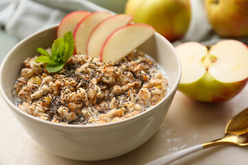 Bowl with tasty sweet oatmeal on table