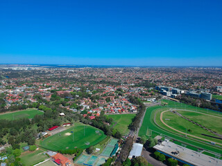 Panoramic Aerial Drone view of Suburban Sydney housing, roof tops, the streets and the parks