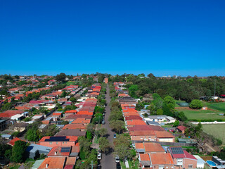 Panoramic Aerial Drone view of Suburban Sydney housing, roof tops, the streets and the parks