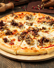 Closeup on pizza with beef meat under the cheese