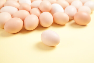 Eggs on yellow background. Food concept
