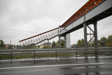 Fototapeta na wymiar Facilitation of displacement for pedestrians. Pedestrian and disabled footbridge above the highway