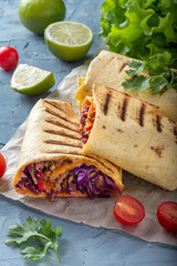 Traditional Mexican burrito with meat and vegetables. Meat wrapped in a cheese tortilla with vegetables