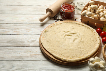 Concept for cooking pizza with ingredients on wooden table
