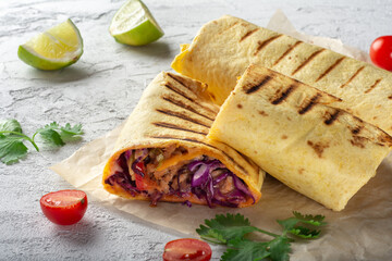 Traditional Mexican burrito with meat and vegetables. Meat wrapped in a cheese tortilla with vegetables