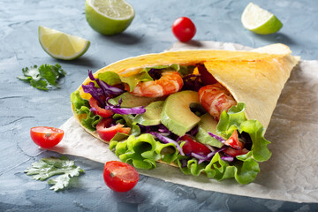 Cheese tortilla with avocado and vegetables. Tortilla with vegetables and shrimp. Tortilla from the sea.