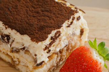 Tiramisu. Traditional italian dessert on wooden plate.