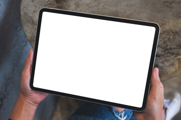 Top view mockup image of a woman holding digital tablet with blank white desktop screen