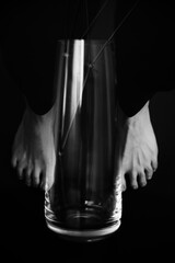 Double multi-exposure, frame overlay. women's feet and a glass vase