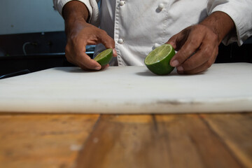 chef grabbing a lemon cut in half