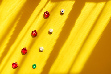 Dice diagonal on a yellow background, beautiful light and shadows. Playing a game with dice. Rolling the dice concept for business risk.