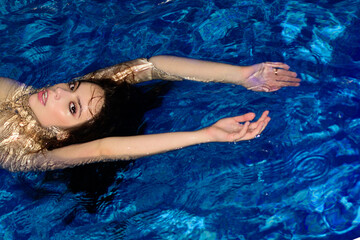 Sexy woman enjoying summer in swimming pool.