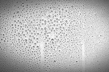 Drops water on the clear glass gray background. Water condensation