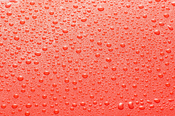 Drops water on the clear glass red background. Water condensation