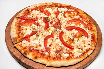 Pizza with bacon, bell pepper, tomatoes and cheese on wooden board. Close-up, selective focus
