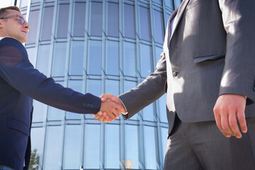 Successful negotiate and handshake concept, two businessman shake hand with partner to celebration...