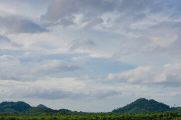 Landscape of Green Mountain and Cloudy Sky.