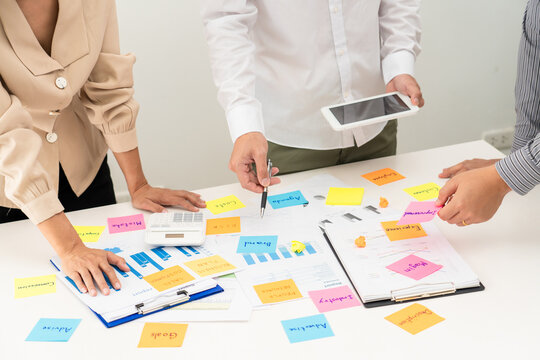 Business People Planning Startup Project Placing Sticky Notes Session To Share Idea On Glass Wall, Strategy Analysis Office Concept.