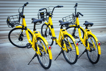 Fototapeta na wymiar Parking for three rental bicycles at street