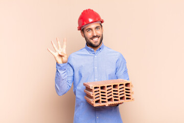 young man smiling and looking friendly, showing number four or fourth with hand forward, counting...