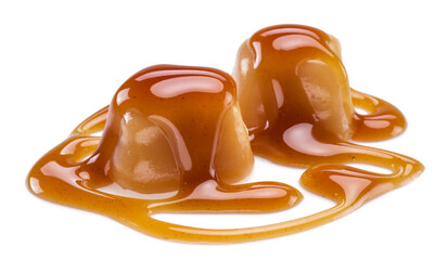 Caramel candies covered with melted sugar caramel isolated on white background.