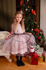 a cute little girl in a dress getting ready for New Year's.