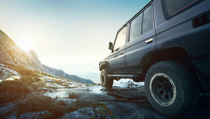 Off road travel concept with 4x4 car at sunset and mountains view © Image Craft