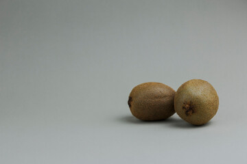 Pair of kiwi fruits close-up on a gray background. Healthy food concept