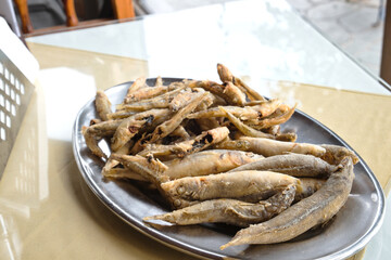 Mediterranean sea catch of the day in the fish tavern of fishing village Zygi on Cyprus - grilled breaded sardines