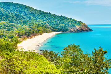 Tropical beach with white sand and green mountain in Koh Lanta island, Thailand