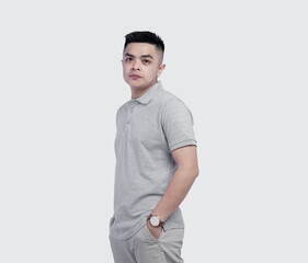 Young handsome man wearing grey polo shirt isolated on white background