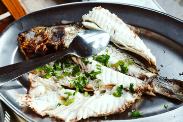 Delicious Cyprus seafood - grilled boneless Mediterranean fish with herbs